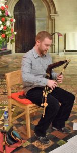 An uilleann pipe player and his instrument